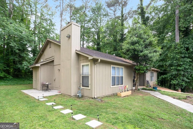 189 Timber Creek Ln, Marietta, GA 30060 - view of front of home featuring a front lawn, a chimney, and a patio