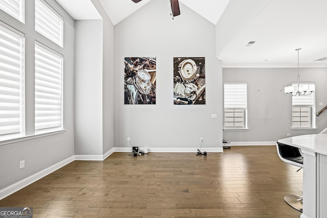 1058 Kirkland Cir, Smyrna, GA 30080 - unfurnished dining area featuring ceiling fan, a chandelier, dark wood finished floors, baseboards, and lofted ceiling