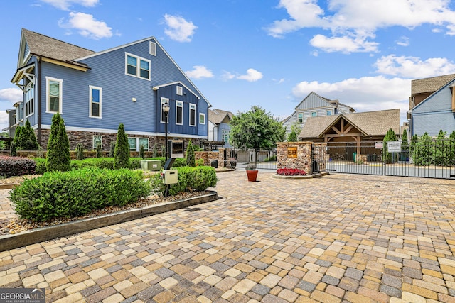 1058 Kirkland Cir, Smyrna, GA 30080 - view of front of property featuring a gate, stone siding, and board and batten siding