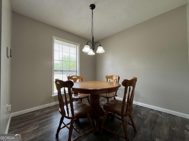 43 Fabian Ln, Hinesville, GA 31313 - dining area with a chandelier, dark wood-type flooring, a textured ceiling, and baseboards