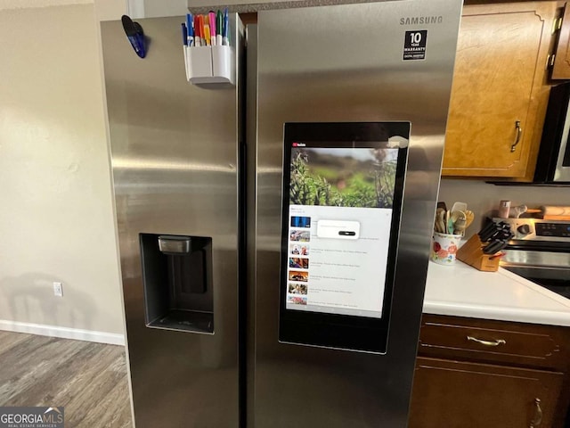 43 Fabian Ln, Hinesville, GA 31313 - kitchen with appliances with stainless steel finishes, wood finished floors, baseboards, and light countertops