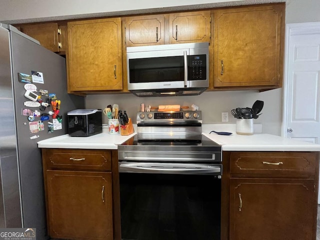 43 Fabian Ln, Hinesville, GA 31313 - kitchen with stainless steel appliances, light countertops, and brown cabinets