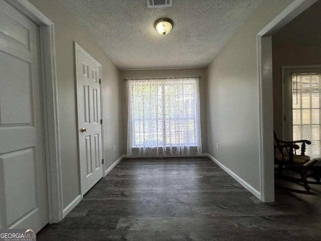 43 Fabian Ln, Hinesville, GA 31313 - unfurnished dining area with a textured ceiling, baseboards, and dark wood finished floors