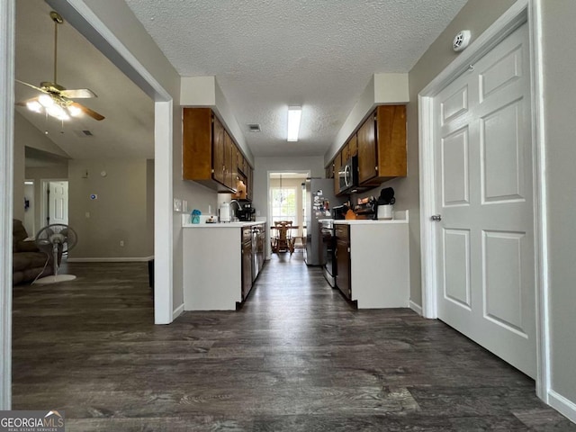 43 Fabian Ln, Hinesville, GA 31313 - kitchen with light countertops, dark wood-type flooring, a ceiling fan, a textured ceiling, and stainless steel microwave