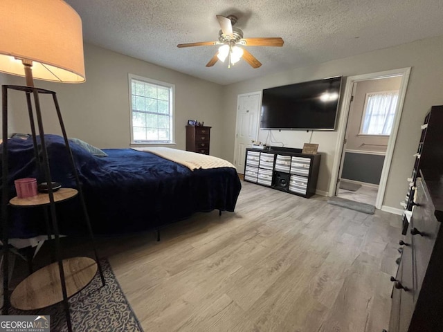 43 Fabian Ln, Hinesville, GA 31313 - bedroom with multiple windows, wood finished floors, a textured ceiling, baseboards, and ceiling fan