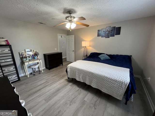 43 Fabian Ln, Hinesville, GA 31313 - bedroom with wood finished floors, baseboards, a textured ceiling, and a ceiling fan