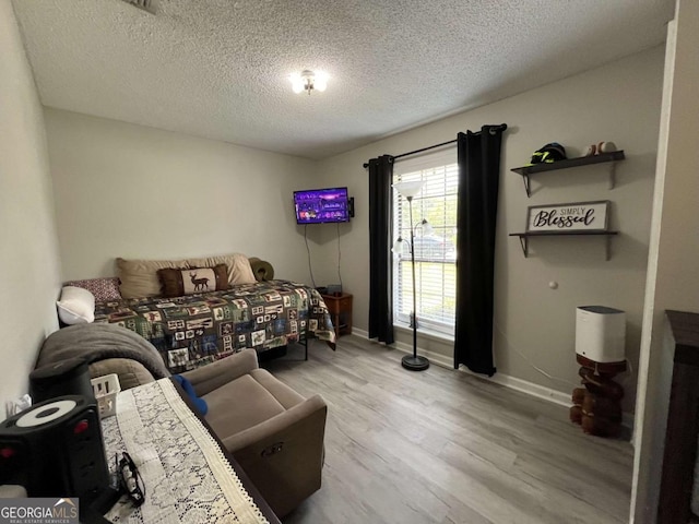 43 Fabian Ln, Hinesville, GA 31313 - bedroom featuring wood finished floors, a textured ceiling, and baseboards