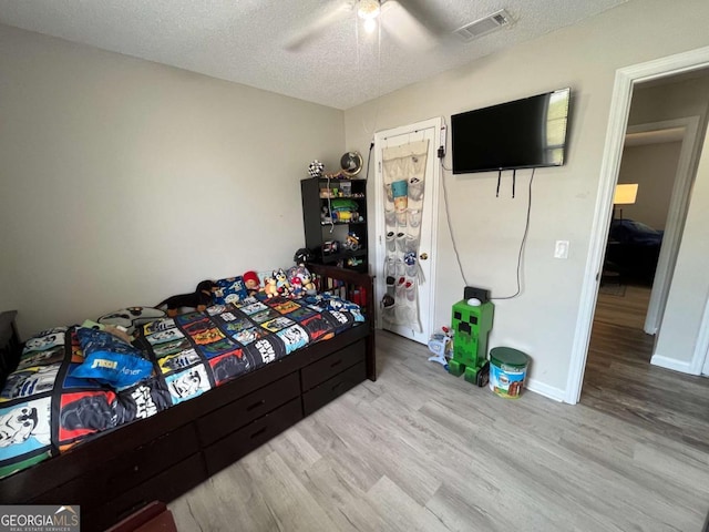 43 Fabian Ln, Hinesville, GA 31313 - bedroom featuring wood finished floors, a textured ceiling, a ceiling fan, and baseboards