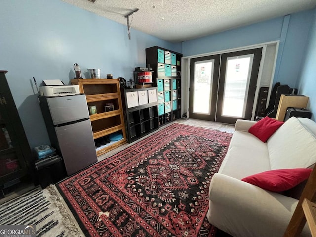 43 Fabian Ln, Hinesville, GA 31313 - living area featuring a textured ceiling and french doors