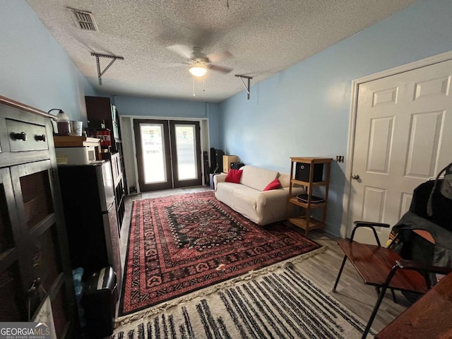 43 Fabian Ln, Hinesville, GA 31313 - living area featuring a ceiling fan, a textured ceiling, french doors, and wood finished floors