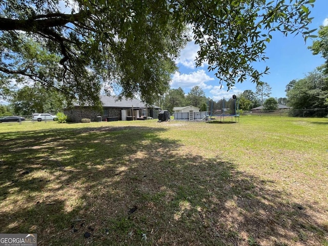 43 Fabian Ln, Hinesville, GA 31313 - view of yard with a trampoline