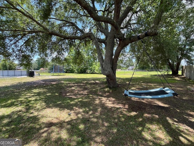 43 Fabian Ln, Hinesville, GA 31313 - view of yard featuring a trampoline