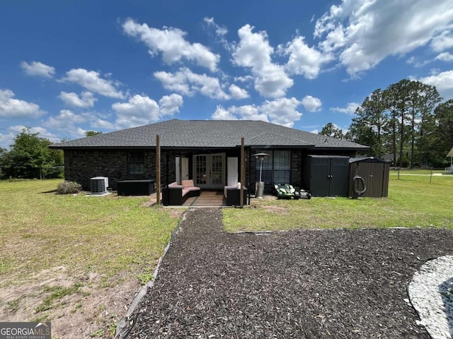 43 Fabian Ln, Hinesville, GA 31313 - back of house with french doors, central air condition unit, a yard, and roof with shingles