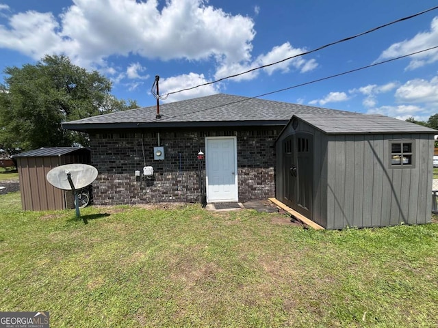43 Fabian Ln, Hinesville, GA 31313 - rear view of house with a yard, a shingled roof, and brick siding