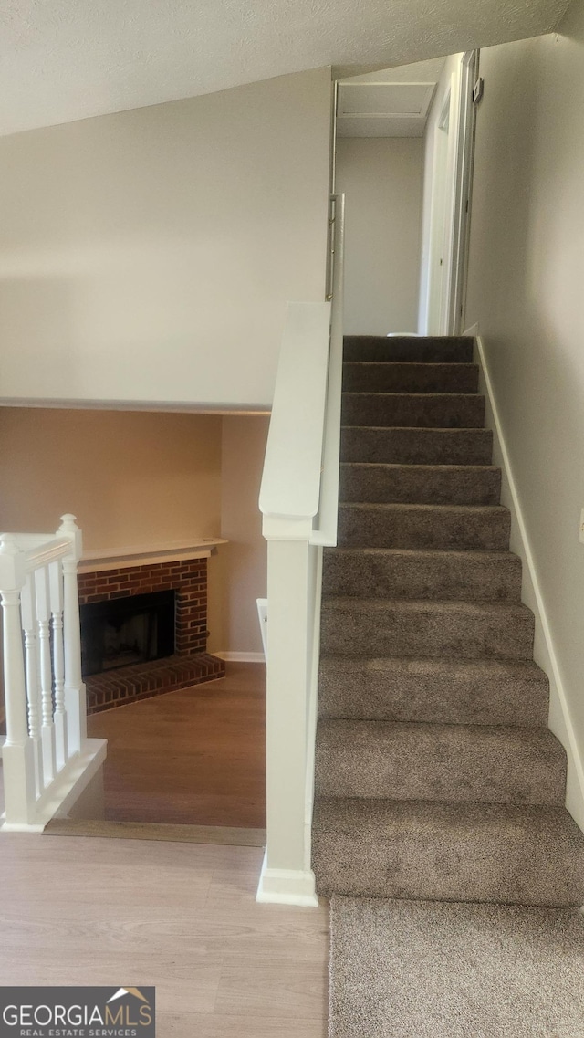 6120 Raleigh Oaks Ct, Lithonia, GA 30058 - staircase featuring wood finished floors, a fireplace, and baseboards