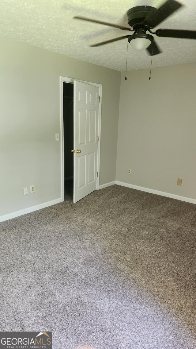 6120 Raleigh Oaks Ct, Lithonia, GA 30058 - carpeted spare room with a ceiling fan, baseboards, and a textured ceiling
