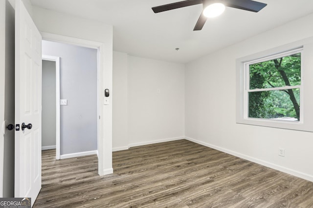 6072 Holiday Blvd, Forest Park, GA 30297 - empty room with dark wood-style flooring, baseboards, and a ceiling fan