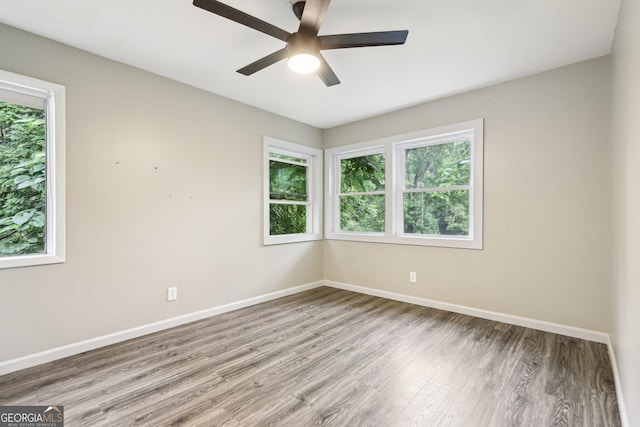6072 Holiday Blvd, Forest Park, GA 30297 - spare room with wood finished floors, baseboards, and ceiling fan