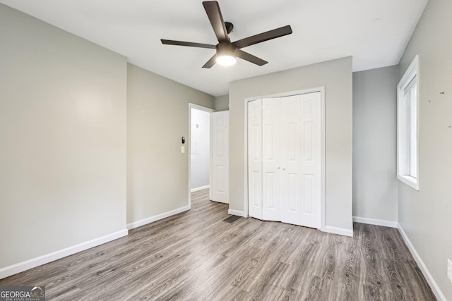 6072 Holiday Blvd, Forest Park, GA 30297 - unfurnished bedroom featuring wood finished floors, baseboards, a closet, and a ceiling fan