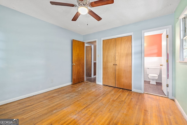 136 Briarwood Dr, Toccoa, GA 30577 - unfurnished bedroom featuring hardwood / wood-style flooring, a closet, ensuite bathroom, tile walls, and a ceiling fan