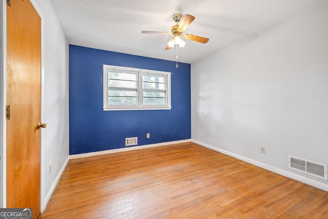 136 Briarwood Dr, Toccoa, GA 30577 - empty room with light wood-type flooring, a textured ceiling, a ceiling fan, and baseboards