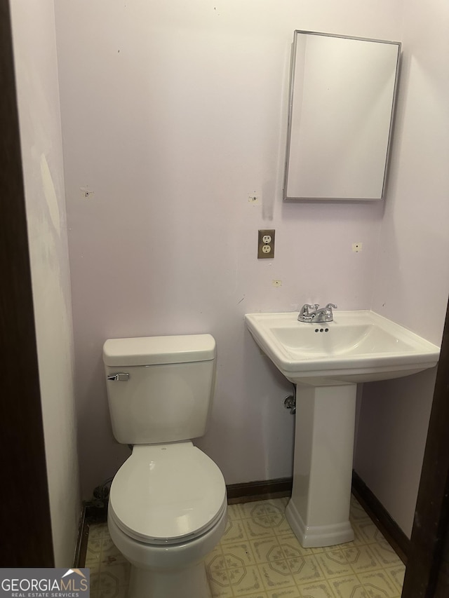 421 Chase Cir, Cornelia, GA 30531 - half bath featuring toilet, baseboards, a sink, and tile patterned floors