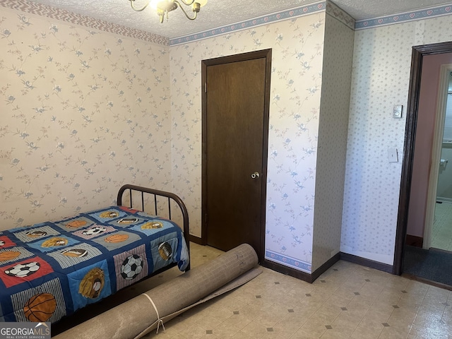 421 Chase Cir, Cornelia, GA 30531 - bedroom featuring a chandelier, a textured ceiling, wallpapered walls, baseboards, and light floors