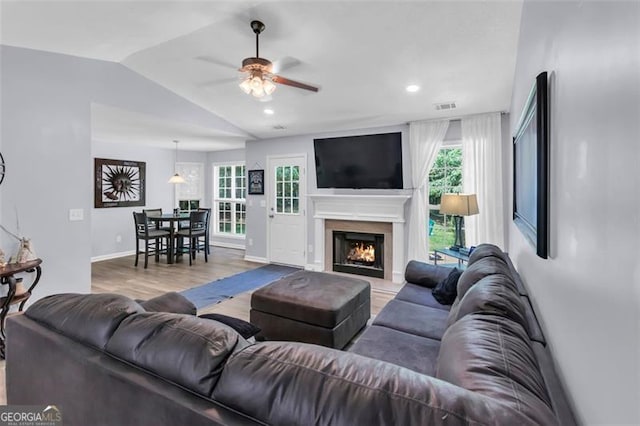 333 Ivy Hills Cir, Mount Airy, GA 30563 - living room featuring a ceiling fan, vaulted ceiling, wood finished floors, a warm lit fireplace, and recessed lighting