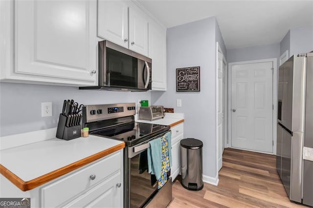 333 Ivy Hills Cir, Mount Airy, GA 30563 - kitchen featuring stainless steel appliances, white cabinetry, light wood-style floors, and light countertops