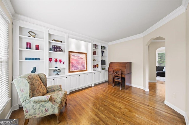 161 Highgrove Dr, Suwanee, GA 30024 - living area with arched walkways, ornamental molding, light wood-style floors, and baseboards