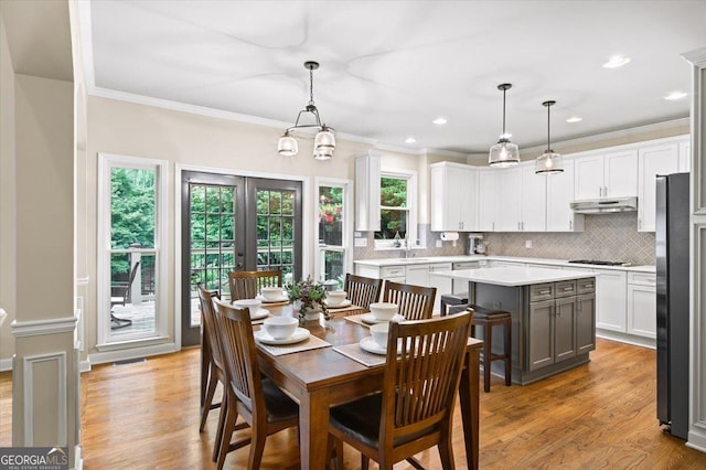 161 Highgrove Dr, Suwanee, GA 30024 - dining room featuring ornamental molding, light wood-style floors, recessed lighting, and a chandelier