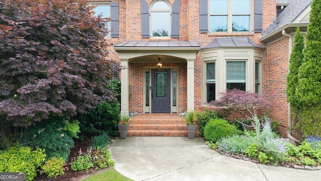 161 Highgrove Dr, Suwanee, GA 30024 - doorway to property featuring brick siding and a standing seam roof