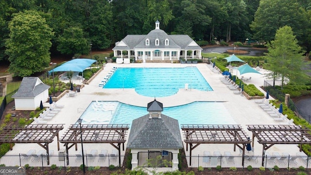 161 Highgrove Dr, Suwanee, GA 30024 - community pool featuring a pergola, a patio, a view of trees, and an outbuilding