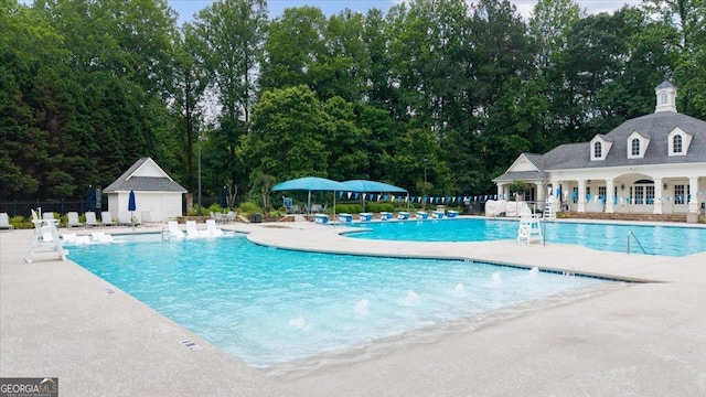 161 Highgrove Dr, Suwanee, GA 30024 - community pool featuring a patio area and view of wooded area