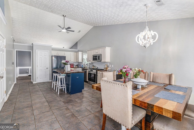 1108 The By Way, Mcdonough, GA 30252 - dining space with a chandelier, ceiling fan, and high vaulted ceiling