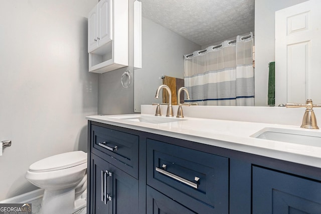 1108 The By Way, Mcdonough, GA 30252 - bathroom with double vanity, toilet, a textured ceiling, and baseboards
