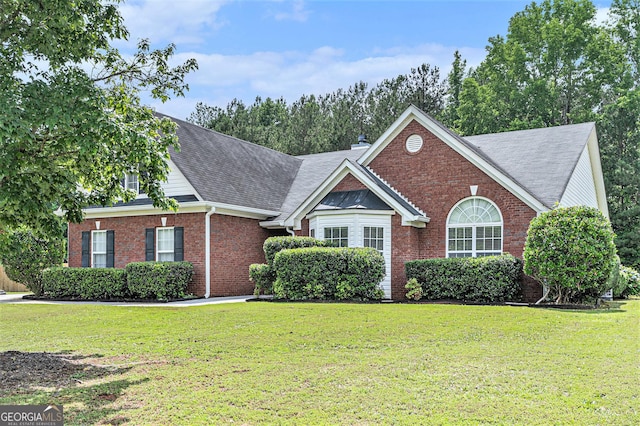 1108 The By Way, Mcdonough, GA 30252 - view of front facade with brick siding, a front yard, and roof with shingles