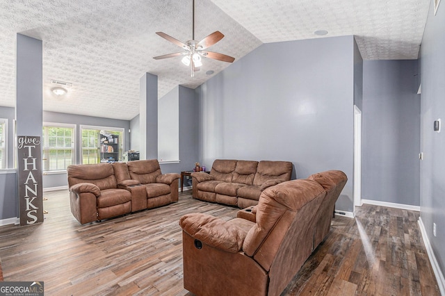 1108 The By Way, Mcdonough, GA 30252 - living area with wood finished floors, lofted ceiling, ceiling fan, baseboards, and a textured ceiling