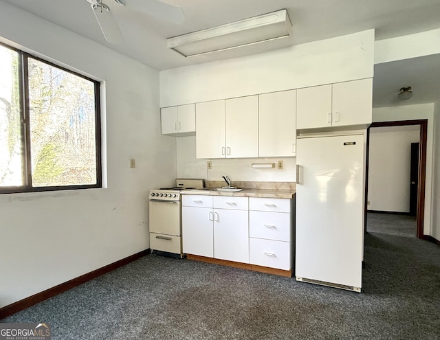 215 Audubon Ln, Clarkesville, GA 30523 - kitchen with white appliances, white cabinets, dark colored carpet, light countertops, and a sink