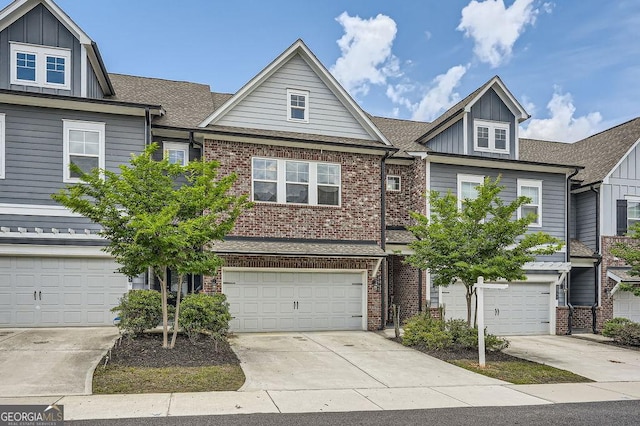 2543 Oakbourne Ln Unit 14, Smyrna, GA 30080 - multi unit property featuring board and batten siding, brick siding, driveway, an attached garage, and a shingled roof