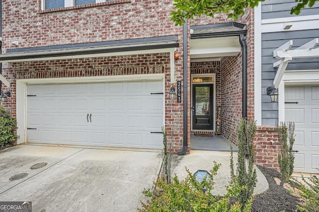 2543 Oakbourne Ln Unit 14, Smyrna, GA 30080 - property entrance featuring brick siding, a garage, and driveway