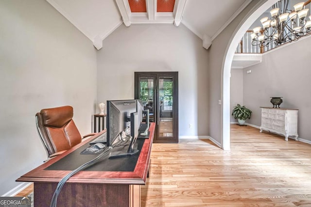 1325 Starboard Way, Cumming, GA 30041 - home office with beam ceiling, arched walkways, light wood-style floors, high vaulted ceiling, and a chandelier