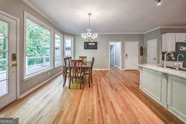1325 Starboard Way, Cumming, GA 30041 - dining space featuring a chandelier, baseboards, light wood-type flooring, and ornamental molding