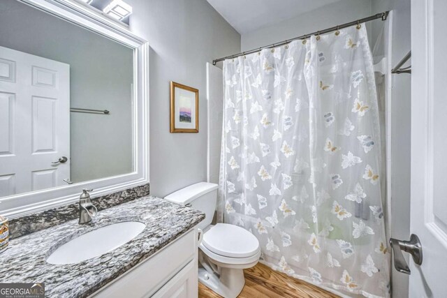 1325 Starboard Way, Cumming, GA 30041 - bathroom featuring vanity, toilet, curtained shower, and wood finished floors