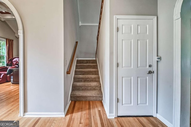 1325 Starboard Way, Cumming, GA 30041 - stairs featuring wood finished floors, baseboards, and arched walkways