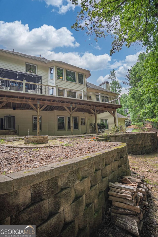 1325 Starboard Way, Cumming, GA 30041 - rear view of house featuring a deck, central AC unit, and a chimney