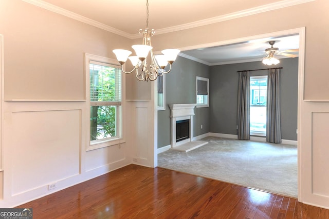 515 Edgewood Dr, Athens, GA 30606 - unfurnished living room featuring wood finished floors, ornamental molding, a chandelier, a decorative wall, and a fireplace with raised hearth