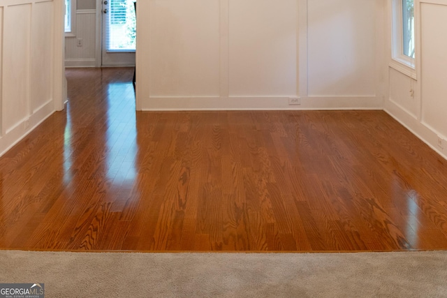 515 Edgewood Dr, Athens, GA 30606 - unfurnished room featuring a decorative wall, wood finished floors, and baseboards
