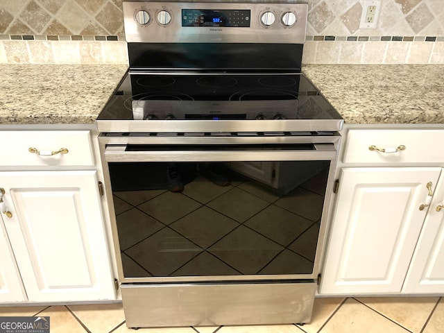7976 Big Creek Pl, Columbus, GA 31904 - kitchen with electric stove, tasteful backsplash, light tile patterned floors, and white cabinetry