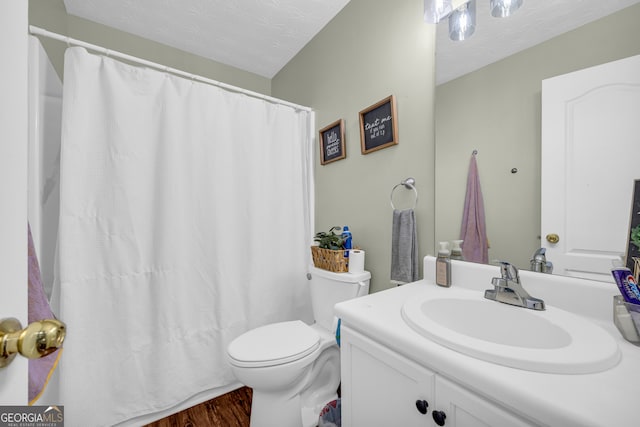 131 Glenn Fuller Cir, Commerce, GA 30529 - full bath with vanity, toilet, wood finished floors, a textured ceiling, and curtained shower
